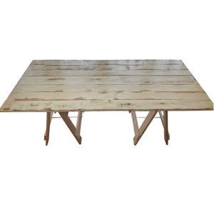 washed pine folding trestle table with a varnished table top and raw solid pine legs